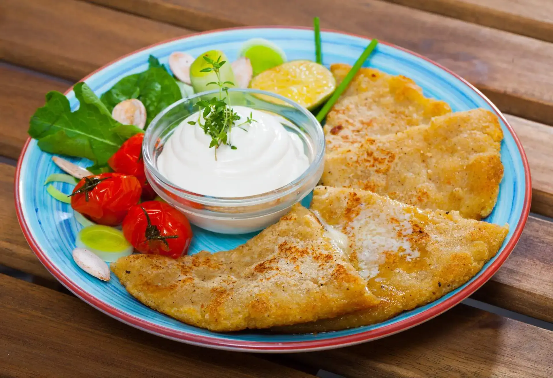 Potato scones served with vegetables and greens on plate â Scottish cuisine