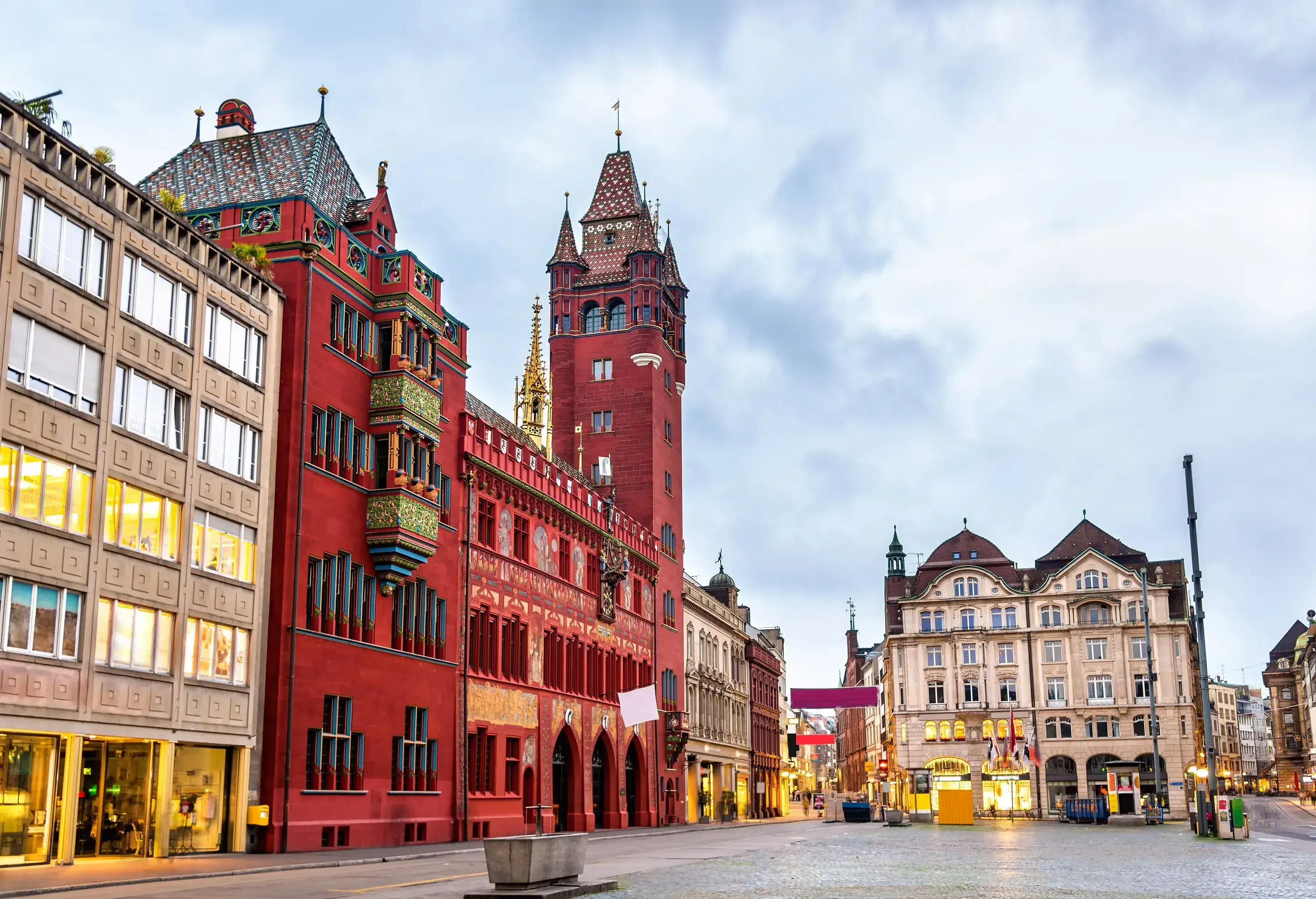 The Town Hall of Basel is surrounded by a charming and historic town square with cobblestone streets and beautiful buildings.