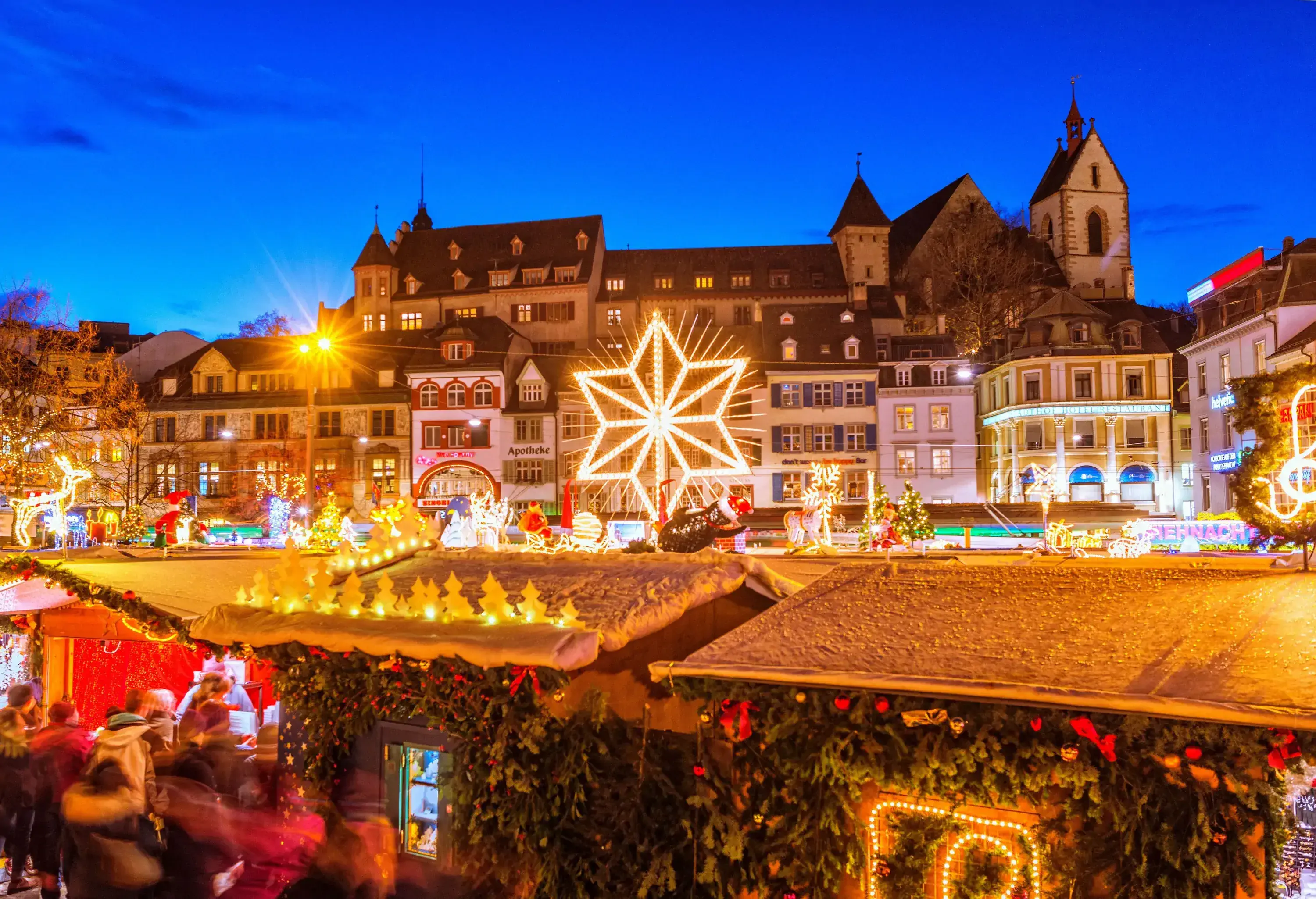 View over the christmas market at the Barfüssplatz in Basel, Switzerland, at dusk.